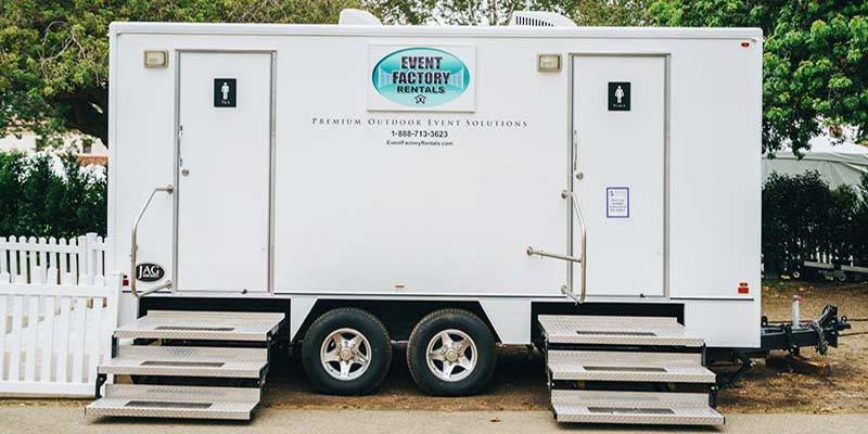 Portable restroom trailer rentals for wedding venues provided by Event Factory Rentals.