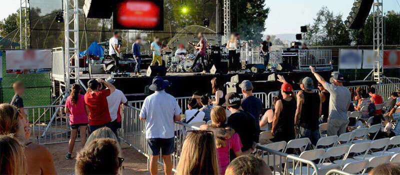 Outdoor concert with crowd barricades and temp fence near Campus, Ventura CA rented from Event Factory Rentals.