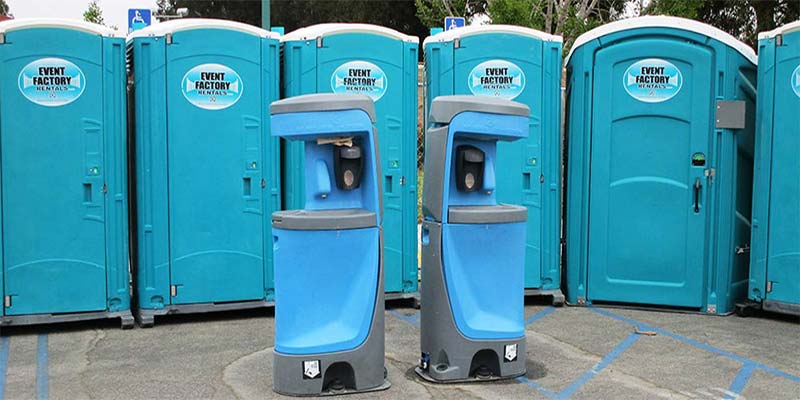 Templeton porta potties lined up with two hand washing stations in front.