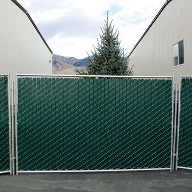 Rent a fence near El Rio East in Oxnard, CA displaying chain-link panels with green privacy slat panels.