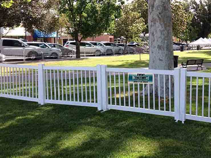 White vinyl picket temporary fencing provided by Event Factory Rentals for outdoor event.