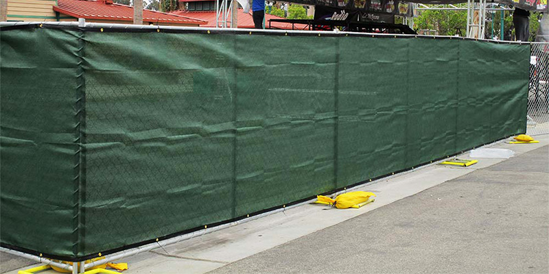 Moveable fence panels near Sherman Oaks with green privacy screen surrounding a music stage.