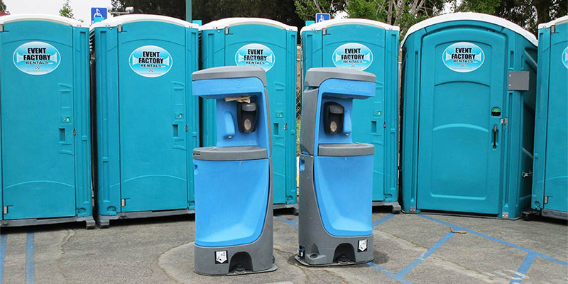 A group of blue porta potty rentals for film and TV productions near Selma, CA.